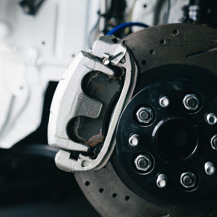 Rear disc brake and caliper during servicing for an electronic parking brake guide
